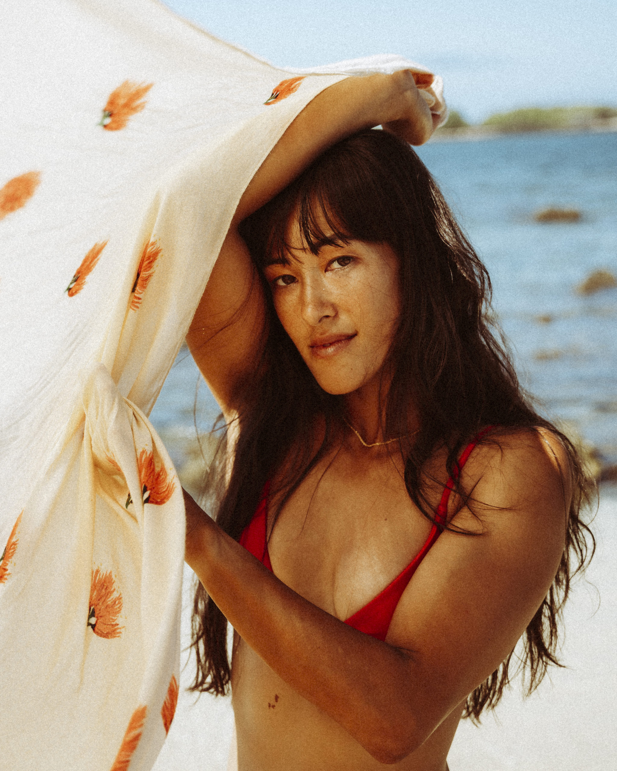 Model in red bikini on beach, Big Island Hawaii